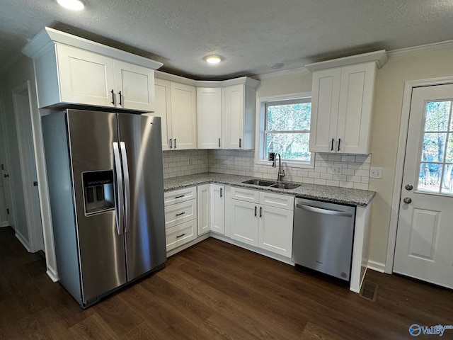 kitchen featuring appliances with stainless steel finishes, dark hardwood / wood-style floors, white cabinetry, and sink