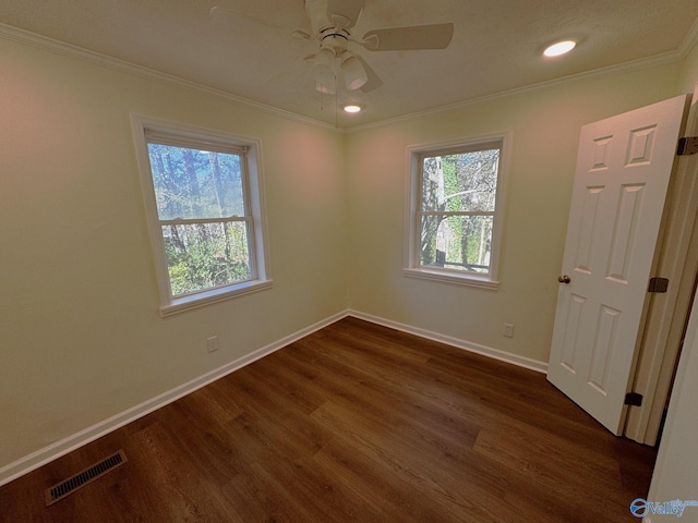 spare room with dark hardwood / wood-style flooring, ceiling fan, and ornamental molding