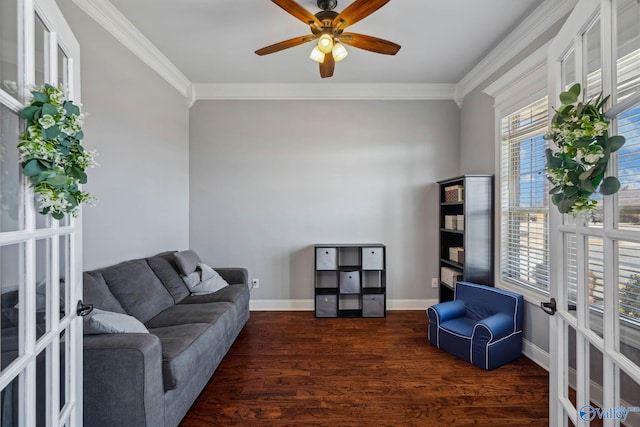 living area featuring baseboards, wood finished floors, crown molding, and french doors