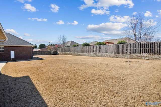 view of yard with a fenced backyard