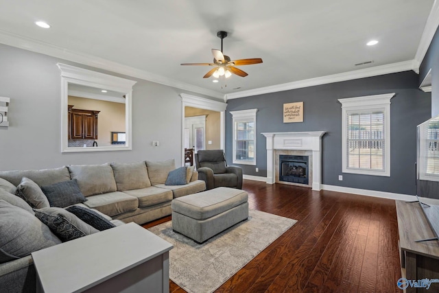 living room featuring a fireplace, dark wood finished floors, visible vents, ornamental molding, and baseboards