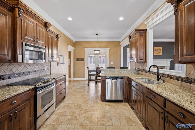 kitchen with crown molding, light stone counters, stainless steel appliances, and a sink