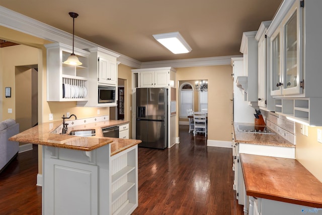 kitchen featuring sink, kitchen peninsula, decorative light fixtures, white cabinets, and appliances with stainless steel finishes