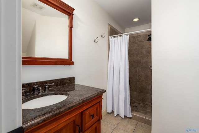 bathroom featuring tile patterned flooring, vanity, and a shower with shower curtain