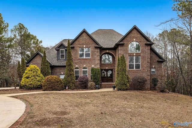 view of front of house featuring french doors and a front lawn