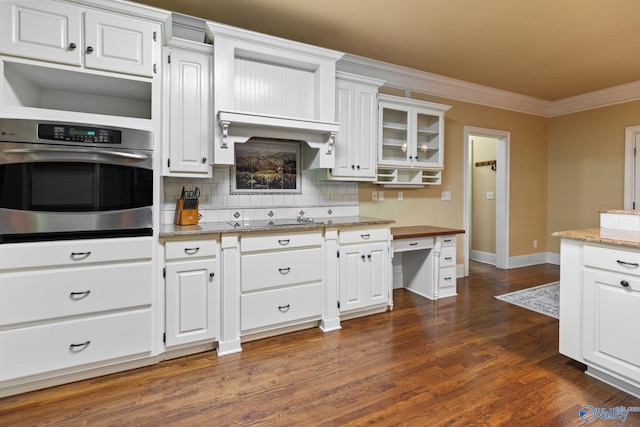 kitchen with white cabinetry, stainless steel oven, light stone countertops, electric cooktop, and decorative backsplash