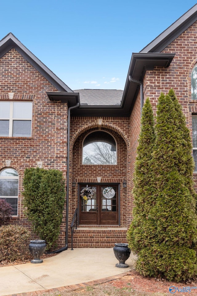 view of exterior entry featuring french doors