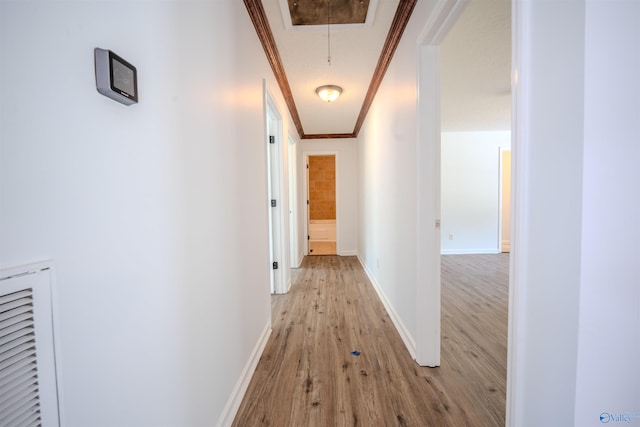 corridor featuring crown molding and light wood-type flooring