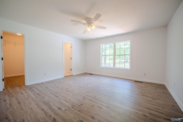 unfurnished room with light hardwood / wood-style floors and ceiling fan