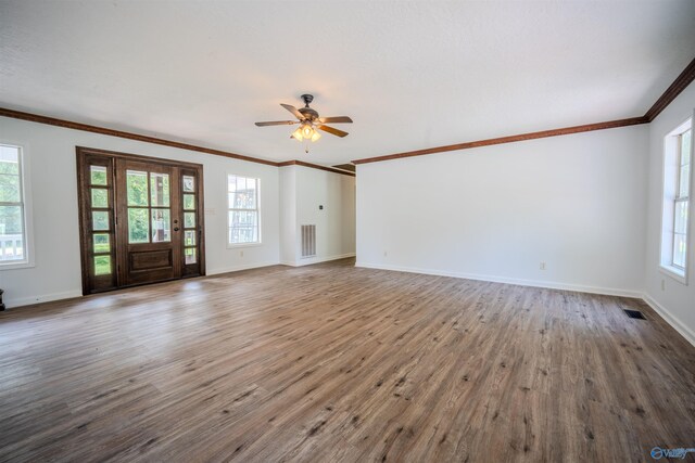 unfurnished living room featuring ceiling fan, hardwood / wood-style flooring, and a wealth of natural light