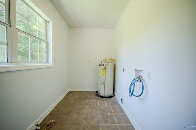 clothes washing area with electric water heater, electric dryer hookup, tile patterned flooring, and washer hookup