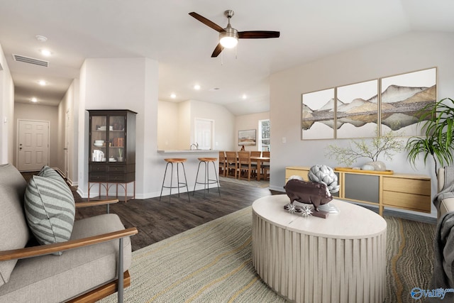 living room with dark wood-type flooring, ceiling fan, lofted ceiling, and sink