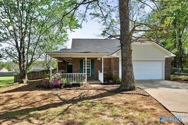 view of front of property featuring concrete driveway, fence, a porch, a garage, and brick siding