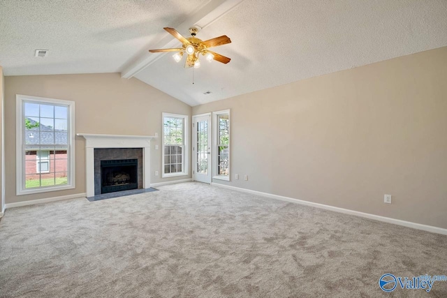 unfurnished living room with plenty of natural light, carpet flooring, and a ceiling fan