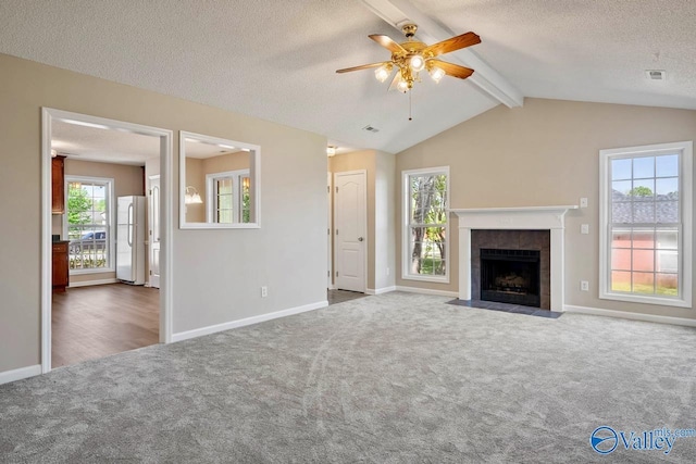 unfurnished living room with a ceiling fan, carpet floors, a fireplace, baseboards, and visible vents