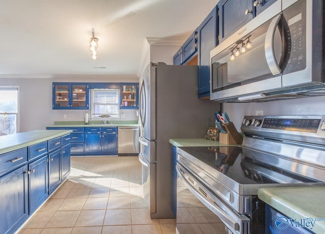 kitchen with light tile patterned floors, stainless steel appliances, light countertops, crown molding, and blue cabinets