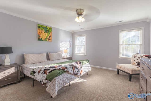 bedroom featuring visible vents, ornamental molding, carpet floors, baseboards, and ceiling fan