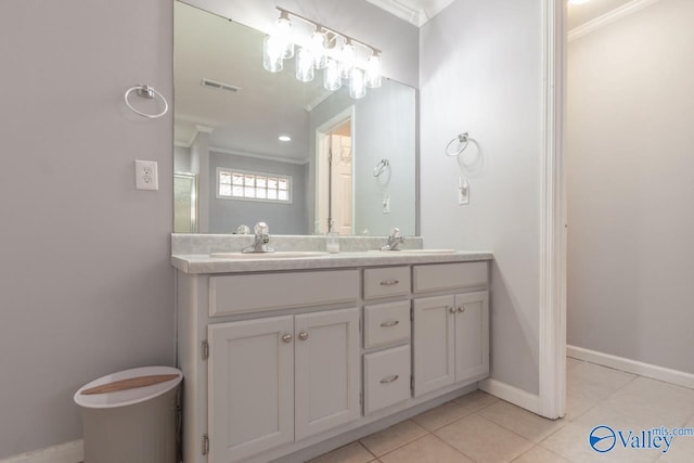 bathroom featuring crown molding, tile patterned floors, and a sink