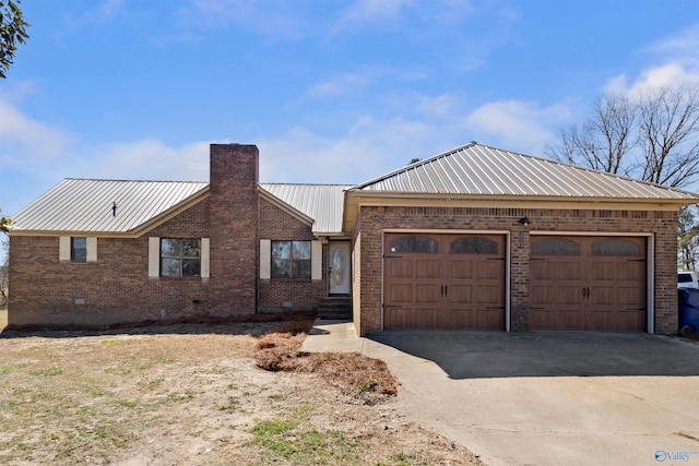 ranch-style house featuring brick siding, a chimney, crawl space, metal roof, and driveway