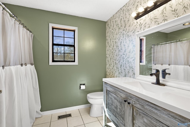 bathroom with wallpapered walls, baseboards, toilet, tile patterned floors, and vanity