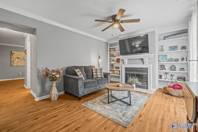 2823 Wynterhall Rd, Huntsville, AL 35803 - living room with crown molding, wood finished floors, a fireplace with flush hearth, ceiling fan, and baseboards