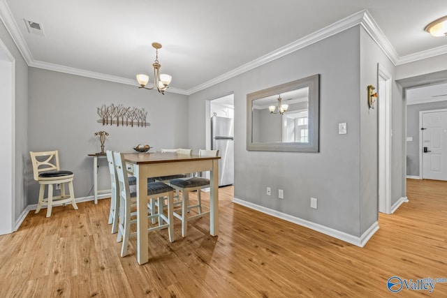 2823 Wynterhall Rd, Huntsville, AL 35803 - dining room with light wood-type flooring, baseboards, and an inviting chandelier