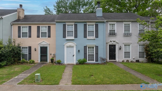 2823 Wynterhall Rd, Huntsville, AL 35803 - view of front of property with a chimney, a front yard, and stucco siding