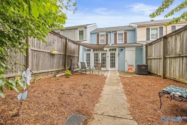 2823 Wynterhall Rd, Huntsville, AL 35803 - back of house featuring central air condition unit, french doors, a fenced backyard, a patio, and stucco siding