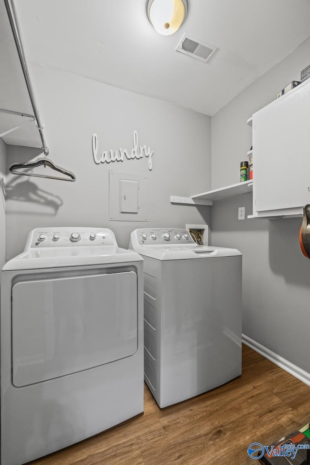 2823 Wynterhall Rd, Huntsville, AL 35803 - washroom featuring washing machine and clothes dryer, baseboards, visible vents, wood finished floors, and laundry area