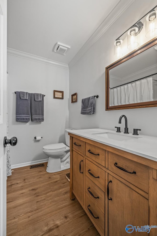 2823 Wynterhall Rd, Huntsville, AL 35803 - full bath with toilet, visible vents, wood finished floors, vanity, and ornamental molding