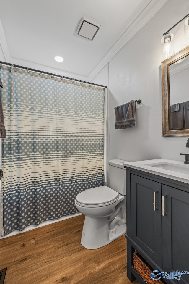2823 Wynterhall Rd, Huntsville, AL 35803 - full bathroom with wood finished floors, vanity, toilet, ornamental molding, and visible vents