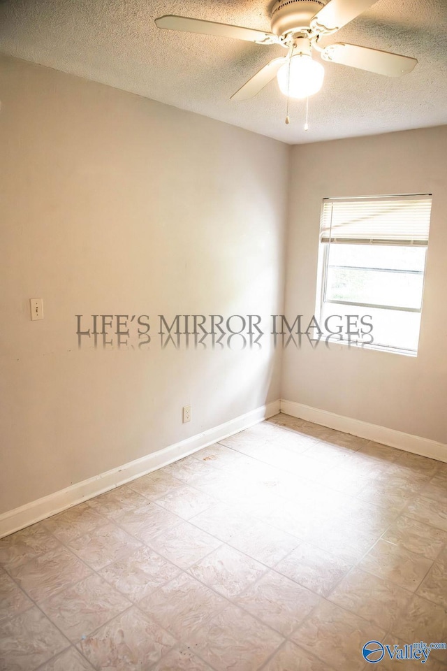 525 Quincy St, Scottsboro, AL 35768 - spare room with a textured ceiling, ceiling fan, and baseboards
