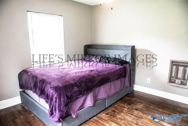525 Quincy St, Scottsboro, AL 35768 - bedroom featuring heating unit, baseboards, and wood-type flooring