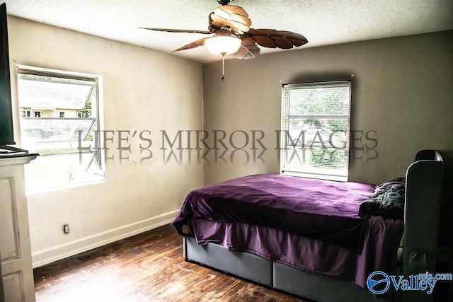 525 Quincy St, Scottsboro, AL 35768 - bedroom with baseboards, wood finished floors, a textured ceiling, and ceiling fan