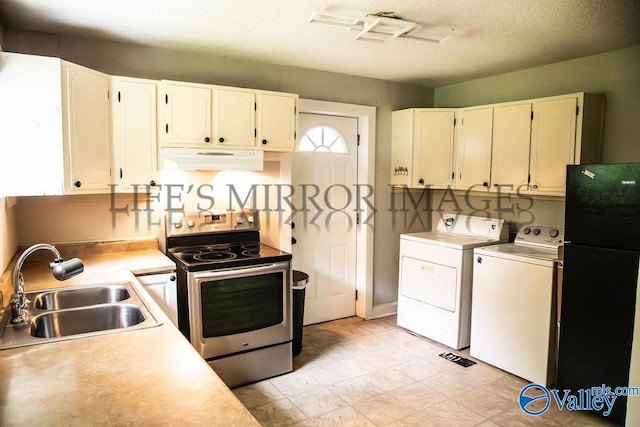 525 Quincy St, Scottsboro, AL 35768 - kitchen featuring electric stove, a sink, under cabinet range hood, freestanding refrigerator, and washing machine and clothes dryer