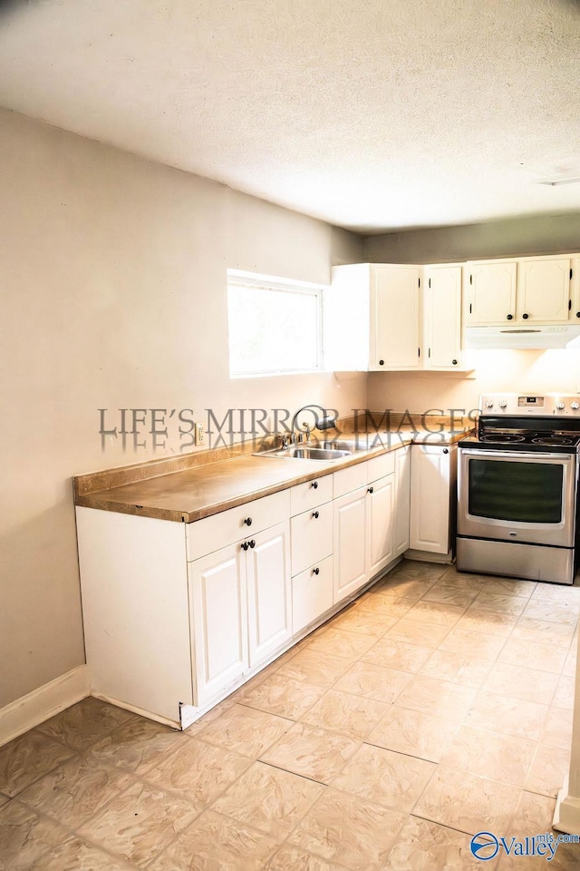 525 Quincy St, Scottsboro, AL 35768 - kitchen with electric range, under cabinet range hood, white cabinets, a sink, and a textured ceiling