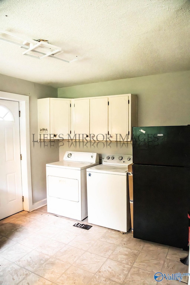 525 Quincy St, Scottsboro, AL 35768 - laundry area featuring cabinet space, washing machine and dryer, and a textured ceiling