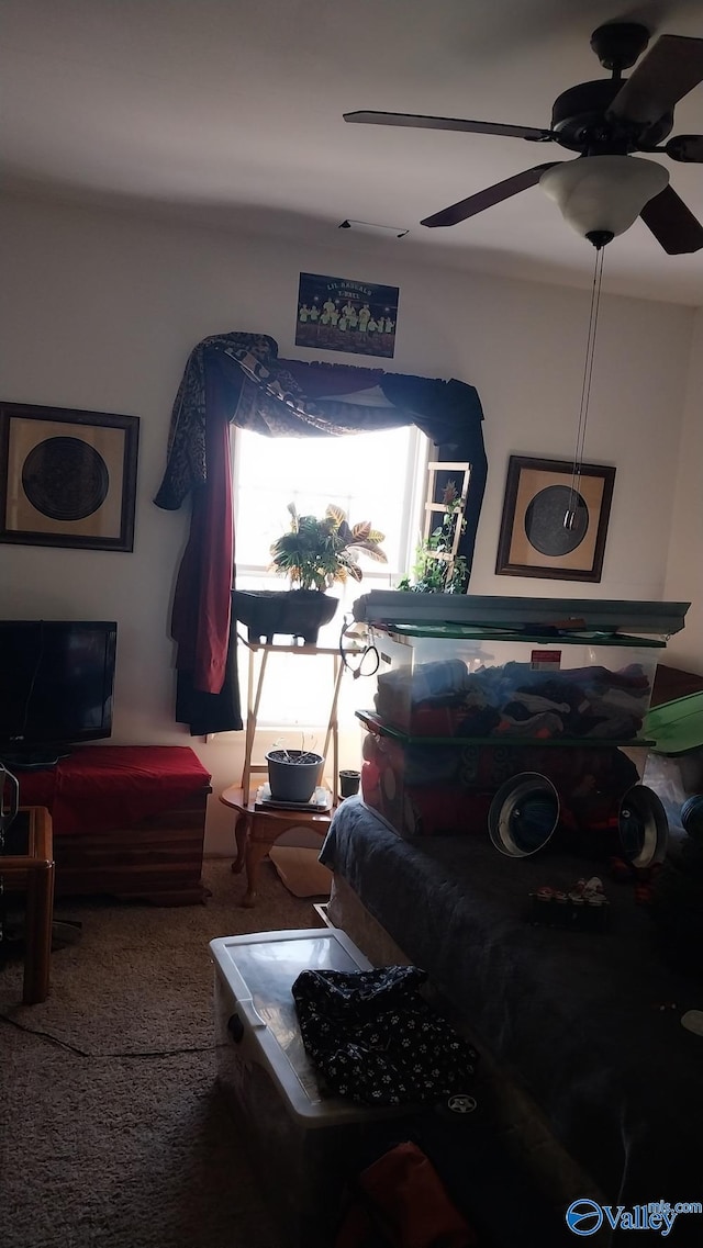 living room featuring ceiling fan and carpet