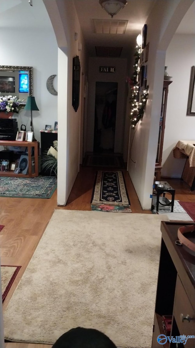 hallway with hardwood / wood-style floors