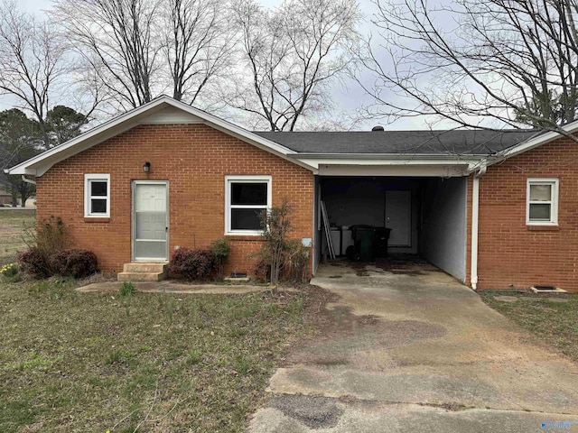 single story home featuring driveway, entry steps, crawl space, an attached carport, and brick siding