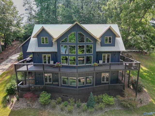 back of house featuring french doors, central air condition unit, and board and batten siding