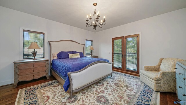 bedroom with a notable chandelier, hardwood / wood-style flooring, and access to exterior