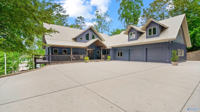 view of front facade with board and batten siding, covered porch, and driveway