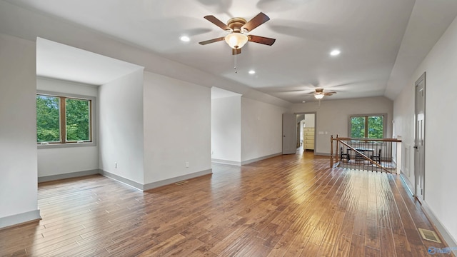 spare room featuring wood-type flooring, ceiling fan, and lofted ceiling