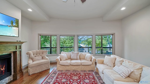 living room with a wealth of natural light, ceiling fan, and hardwood / wood-style floors