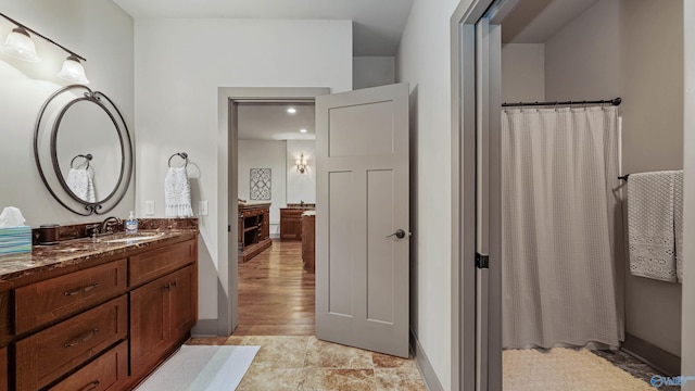 bathroom with vanity and wood-type flooring