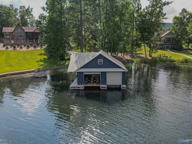 view of dock with a water view and a lawn