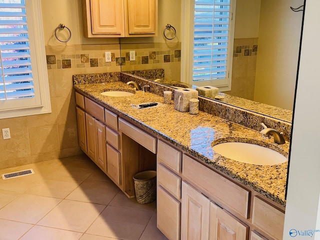 bathroom with tile patterned floors, vanity, and tile walls