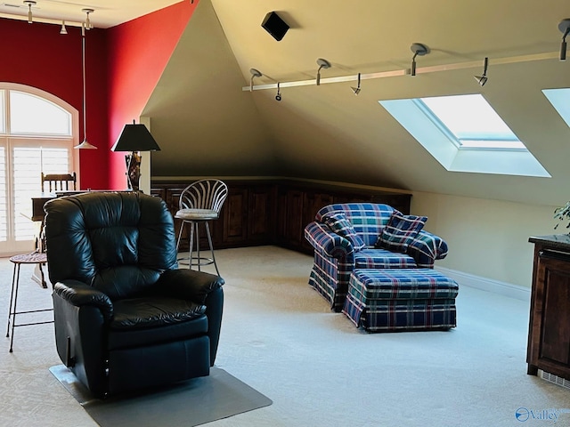 living area with light carpet, rail lighting, and lofted ceiling with skylight