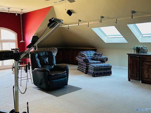 interior space featuring light colored carpet and lofted ceiling with skylight